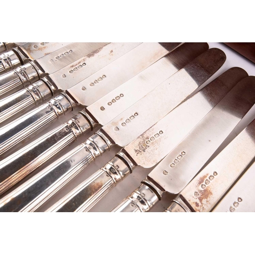 500 - A Victorian silver set of eighteen silver fruit knives and forks, the weighted handles engraved with... 
