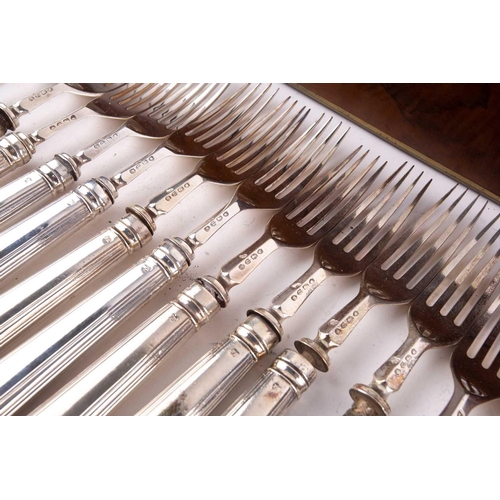 500 - A Victorian silver set of eighteen silver fruit knives and forks, the weighted handles engraved with... 