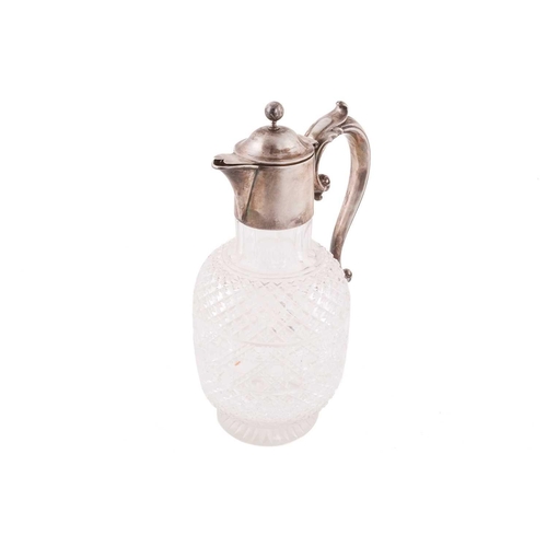 502 - A Victorian silver mounted claret jug; the domed cover with ball finial; leaf- capped scroll handle ... 
