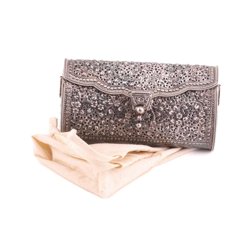 504 - A white metal clutch bag; chased and pierced foliate decoration; hinged cover and hinged clasp.Stamp... 