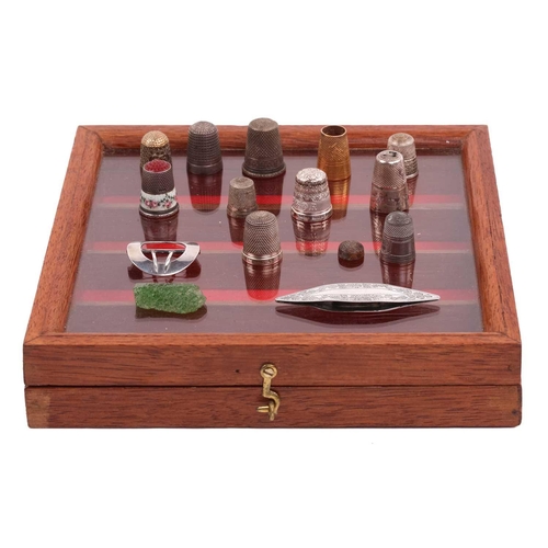 506 - A collection of thimbles of varying dates, including an enamelled decorated example, a gilded exampl... 
