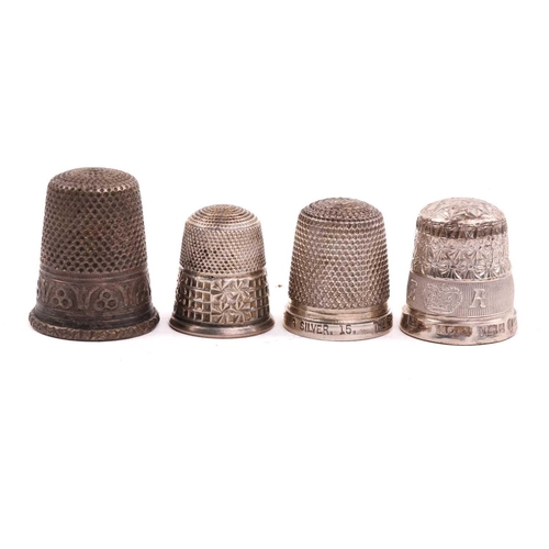 506 - A collection of thimbles of varying dates, including an enamelled decorated example, a gilded exampl... 