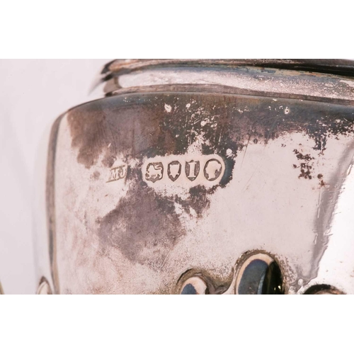507 - A Victorian silver part-fluted teapot with angular ebonised handle, hinged cover and engraved crest ... 