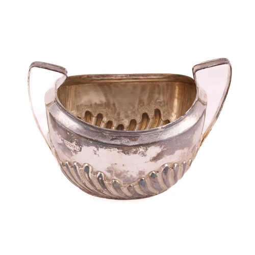 507 - A Victorian silver part-fluted teapot with angular ebonised handle, hinged cover and engraved crest ... 