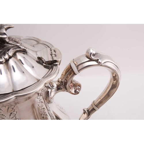 512 - A four piece tea and coffee set; lobed, low bellied panelled form, the panels engraved with foliage ... 