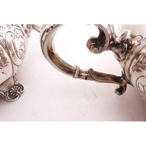 512 - A four piece tea and coffee set; lobed, low bellied panelled form, the panels engraved with foliage ... 