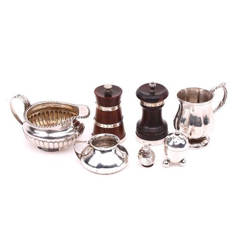 519 - A collection of silver items including silver salt in the form of a bird, a silver mounted pepper mi... 