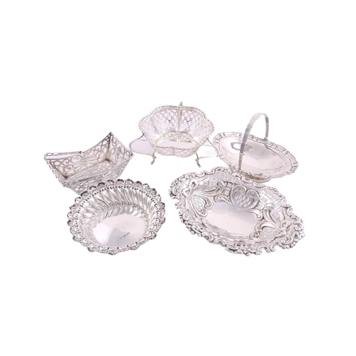 524 - Five assorted silver bon bon dishes comprising two with swing handles (the oval example with filled ... 