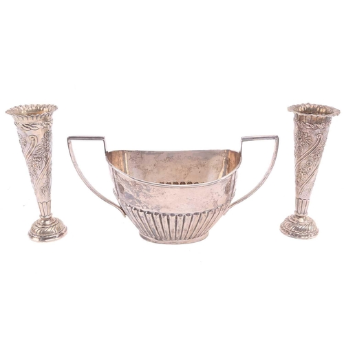 526 - A silver half-reeded sugar basin engraved with a dedication, 6.4ozt together with two weighted silve... 