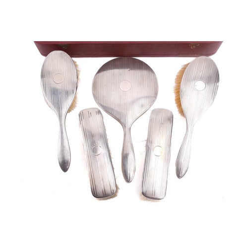 530 - A Mappin and Webb silver dressing set in its original fitted case comprising two hair brushes, two c... 