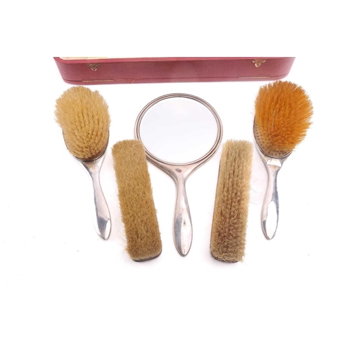 530 - A Mappin and Webb silver dressing set in its original fitted case comprising two hair brushes, two c... 