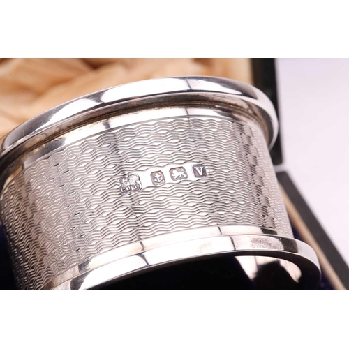 538 - A boxed pair of presentation silver napkin rings, a pair of silver-bladed fish servers (no handles),... 