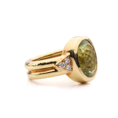 54 - A peridot and diamond dress ring, collet-set with an oval-cut peridot of 12.0 x 9.4 x 5.4 mm, flanke... 