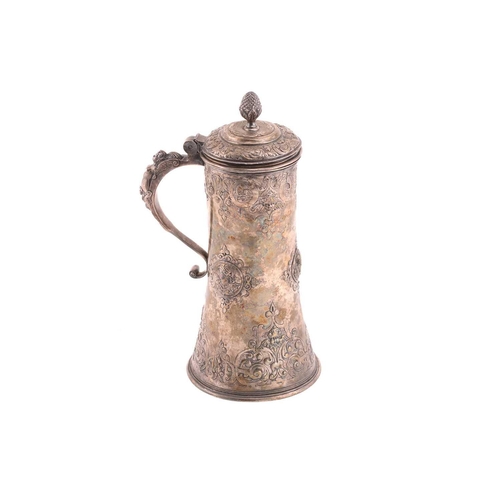 542 - A Hungarian electroplated lidded tankard. Tapering cylindrical with reeded skirt foot; the body with... 