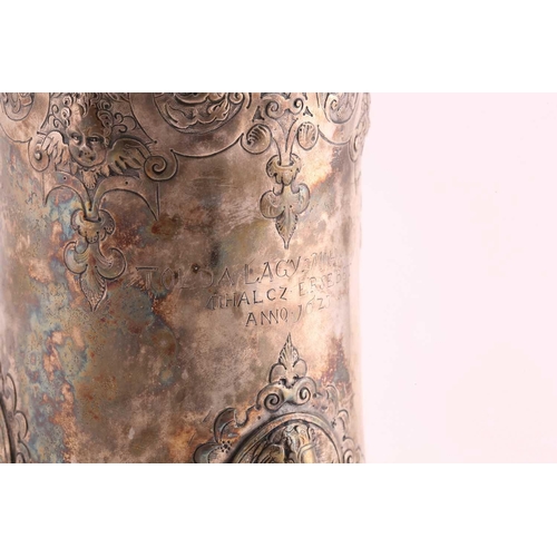 542 - A Hungarian electroplated lidded tankard. Tapering cylindrical with reeded skirt foot; the body with... 