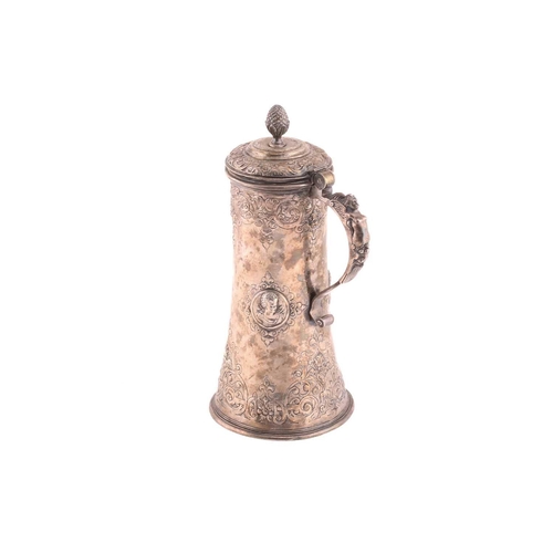 542 - A Hungarian electroplated lidded tankard. Tapering cylindrical with reeded skirt foot; the body with... 