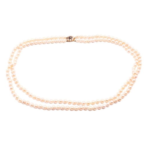 56 - A double-strand cultured pearl necklace, comprising two rows of graduated pearls with cream body col... 