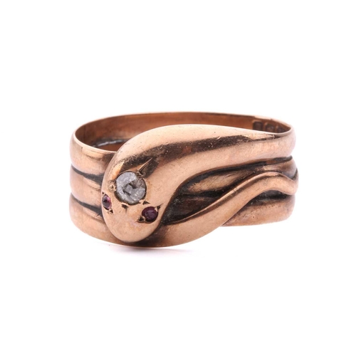 8 - A Victorian snake ring, set with an old cut diamond to the head and red gem-set eyes, in rose gold w... 