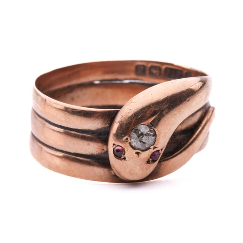 8 - A Victorian snake ring, set with an old cut diamond to the head and red gem-set eyes, in rose gold w... 