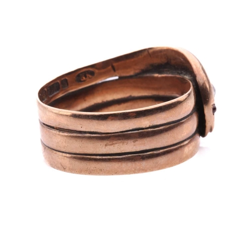 8 - A Victorian snake ring, set with an old cut diamond to the head and red gem-set eyes, in rose gold w... 