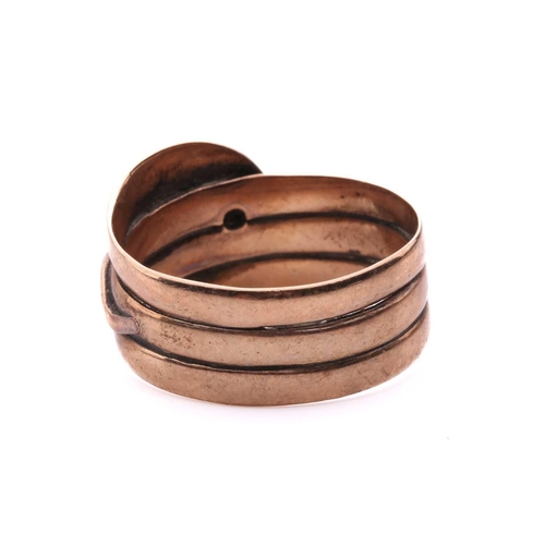 8 - A Victorian snake ring, set with an old cut diamond to the head and red gem-set eyes, in rose gold w... 