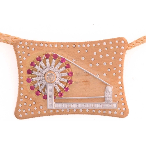 9 - An Indian spinning wheel pendant set with ruby and diamond, featuring an articulated spinning wheel ... 