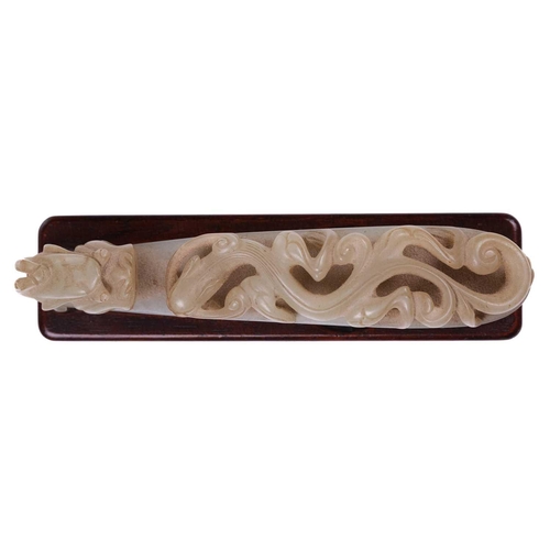 121 - A Chinese carved pale green jade belt hook, carved and pierced with sinuous Chilong and the hook ter... 