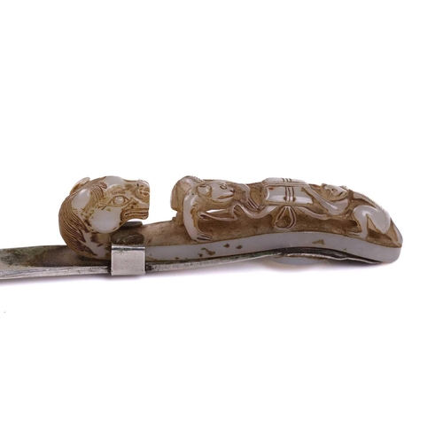 121 - A Chinese carved pale green jade belt hook, carved and pierced with sinuous Chilong and the hook ter... 