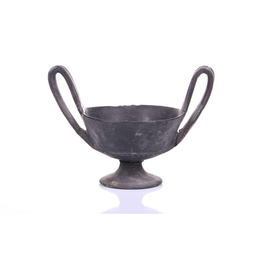 125 - A group of four Etruscan Bucchero-style black pottery vessels, including a large terracotta goblet, ... 