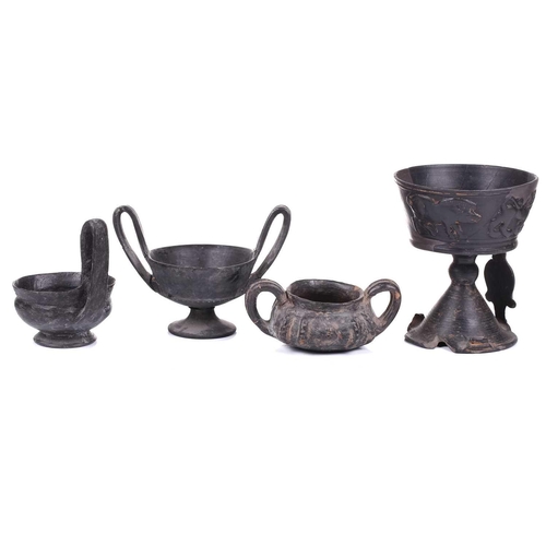 125 - A group of four Etruscan Bucchero-style black pottery vessels, including a large terracotta goblet, ... 