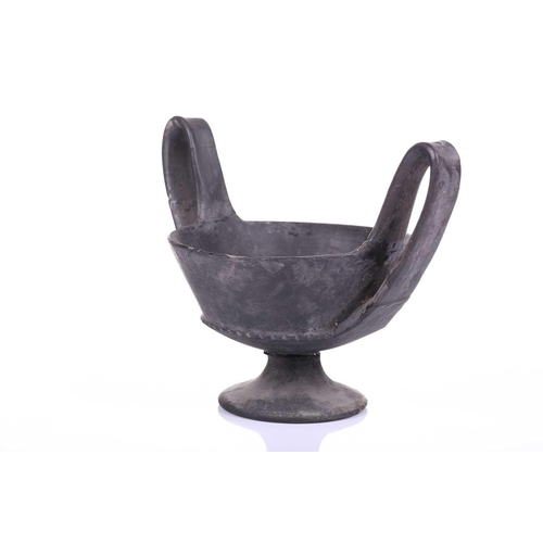 125 - A group of four Etruscan Bucchero-style black pottery vessels, including a large terracotta goblet, ... 