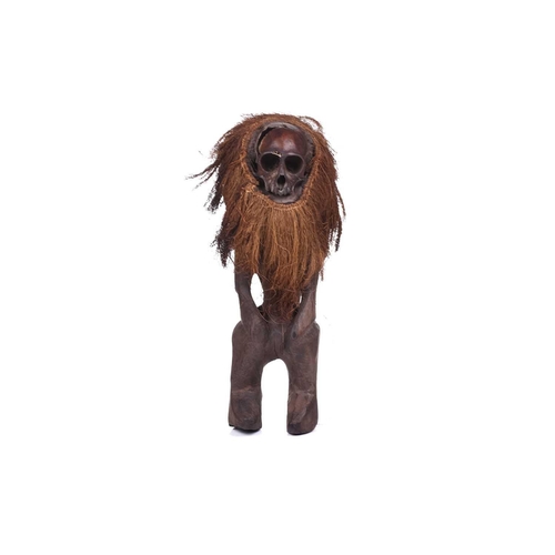 126 - A Cameroonian monkey skull fetish figure with coconut husk fibre ruff, 32 cm high and a collection o... 