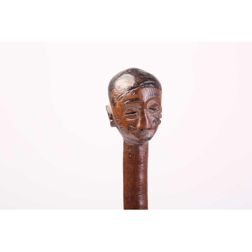 127 - A collection of five African carved wood tribal staffs including two possibly Ovimbundu examples wit... 