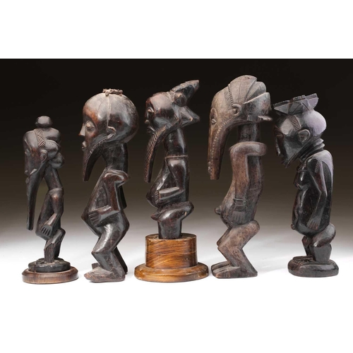 136 - A group of Hemba standing male figures, Democratic Republic of Congo, three with long linear carved ... 