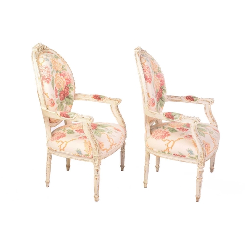 144 - A pair of Louis XVI-style carved painted and distressed fauteuils, 20th century, with cameo-shaped b... 