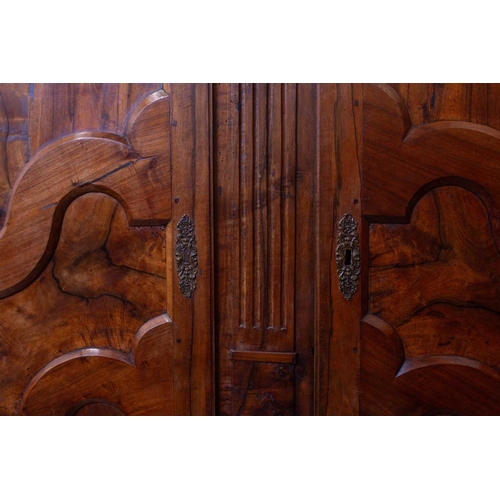 147 - A large French provincial 'Grenoble Walnut' two-door armoire, late 18th century, with later adaptati... 