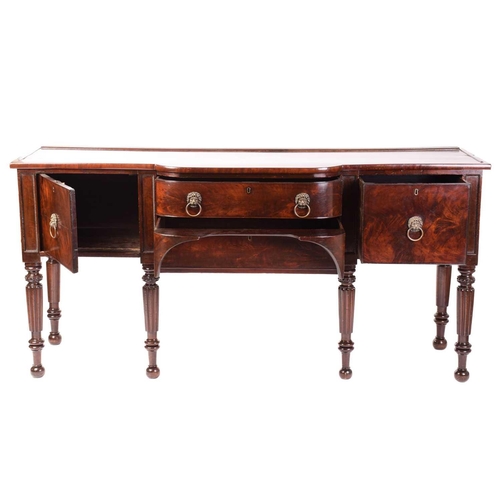 156 - A William IV mahogany breakfront sideboard, the top with plate rest to the back over a bowed centre ... 