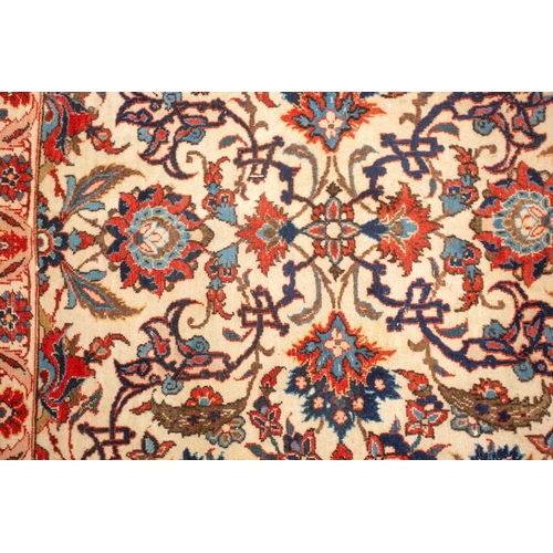 175 - An ivory-ground Najafabad carpet with overall Islimi decoration within brick red palmetted borders. ... 