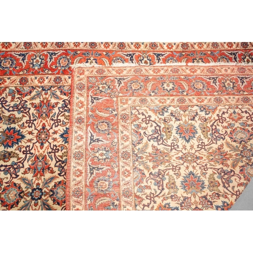 175 - An ivory-ground Najafabad carpet with overall Islimi decoration within brick red palmetted borders. ... 