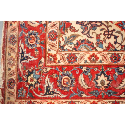 175 - An ivory-ground Najafabad carpet with overall Islimi decoration within brick red palmetted borders. ... 