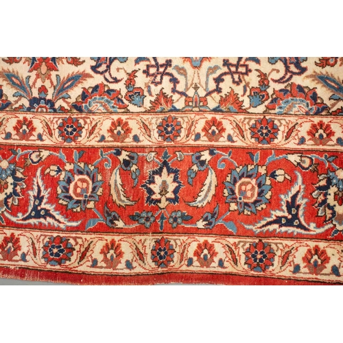 175 - An ivory-ground Najafabad carpet with overall Islimi decoration within brick red palmetted borders. ... 