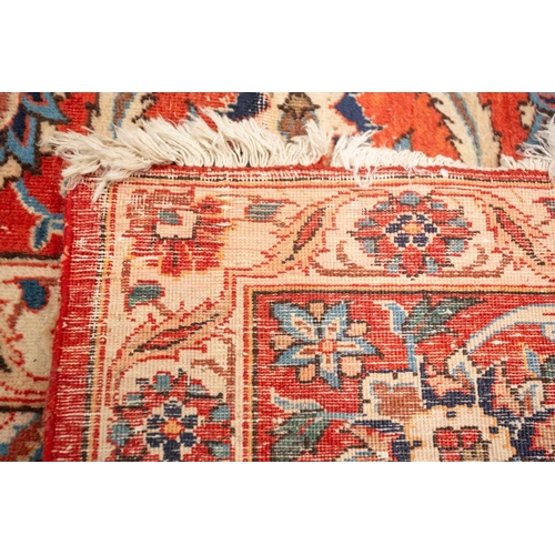 175 - An ivory-ground Najafabad carpet with overall Islimi decoration within brick red palmetted borders. ... 