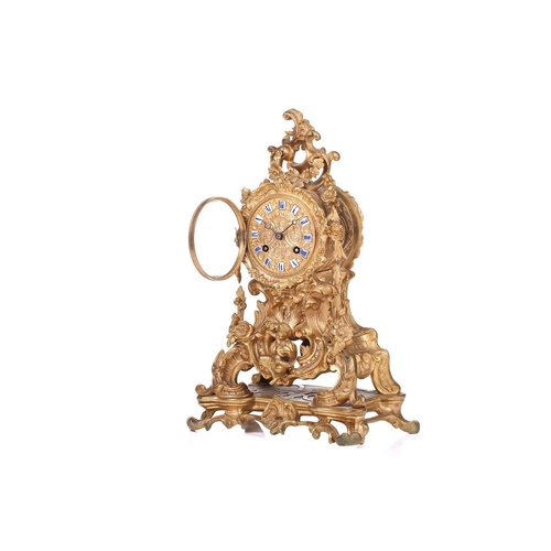 181 - A late 19th century French ormolu clock, with floral garlands and scrolls, the gilt metal dial with ... 