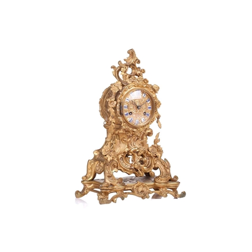 181 - A late 19th century French ormolu clock, with floral garlands and scrolls, the gilt metal dial with ... 