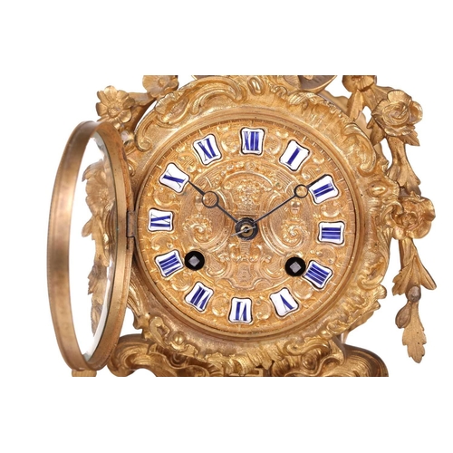 181 - A late 19th century French ormolu clock, with floral garlands and scrolls, the gilt metal dial with ... 