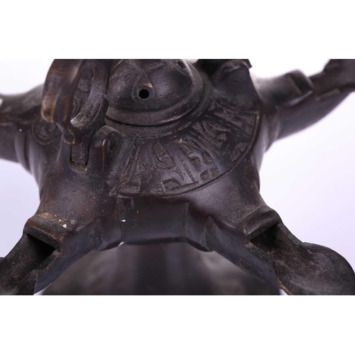 193 - A Bactrian-style oil lamp, with five spouts around a central hinged lid and two mythical beast termi... 