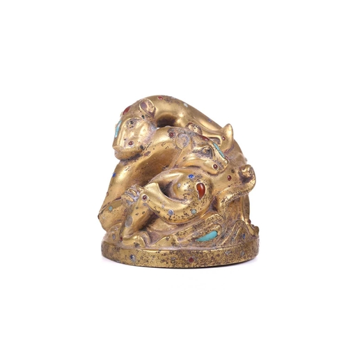 194 - A Chinese gilt bronze Tang-style fighting tiger scroll weight set with polished hardstones, with an ... 