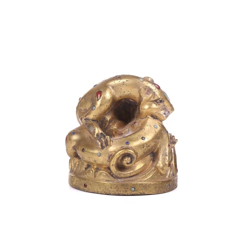 194 - A Chinese gilt bronze Tang-style fighting tiger scroll weight set with polished hardstones, with an ... 