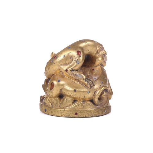 194 - A Chinese gilt bronze Tang-style fighting tiger scroll weight set with polished hardstones, with an ... 