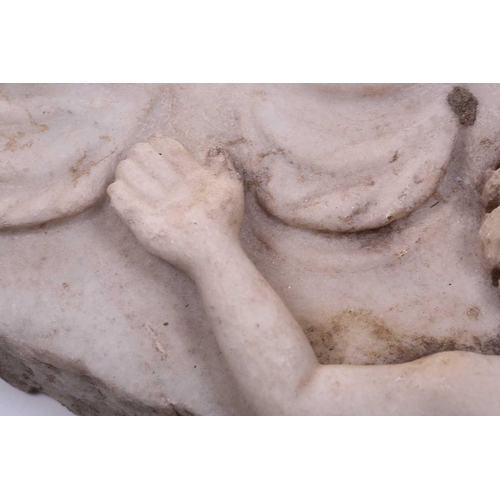 201 - A Roman Marble fragment, 2nd/3rd century AD, possibly part of a sarcophagus, depicitng a youth in ro... 